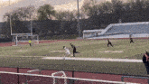 a soccer game is being played on a field with the letters s and t on it