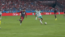a soccer game is being played in front of an old spice advertisement
