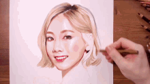 a person is drawing a picture of a woman with short blonde hair