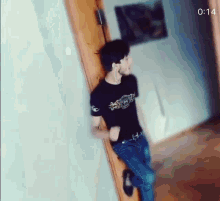 a man leaning against a door with the time 1:14