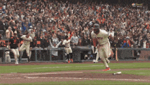 a baseball player wearing a giants jersey is running on the field