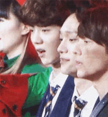 a group of young people are standing next to each other and looking at something .
