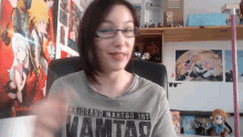 a woman wearing glasses and a shirt that says mamtao