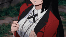 a woman in a red jacket and white shirt has a cross on her collar