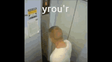 a man in an elevator with the word yrou 'r above him