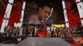 a group of wrestlers are standing in front of a large screen that says ' raw ' on it