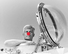 a man with a red nose is looking out of a clear dome