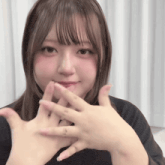 a girl with a ring on her finger is holding her hands together