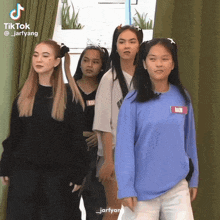 a group of girls are standing next to each other and one of them has a name tag that says bam on it