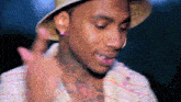 a man wearing a hat has a tattoo on his chest that says " i love you "