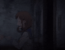 a girl in a school uniform is holding a pair of headphones