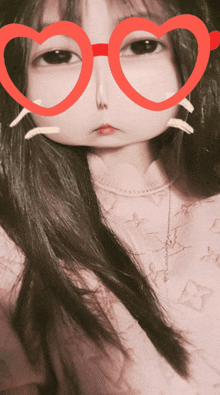 a girl wearing heart shaped glasses looks like she is making a face