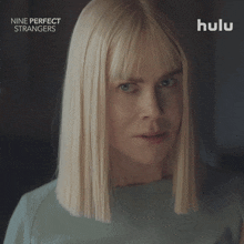 a poster for nine perfect strangers shows a blonde woman covering her ears with her hands