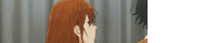 a man and a woman are standing next to each other in front of a curtain and looking at each other .
