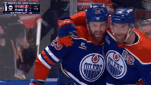 two edmonton oilers hockey players celebrate a goal