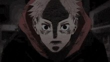 a close up of a person 's face with a shadow on it and a hoodie on .
