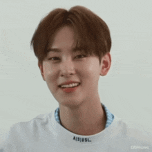 a close up of a young man wearing a white shirt that says ais usl