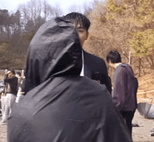 a man in a black jacket with a hood