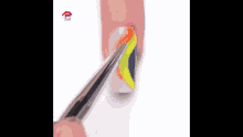 a close up of a person 's nails being painted with a brush .
