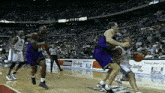 a basketball game is being played in front of a crowd with a banner that says ' tnt ' on it