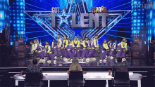 a group of dancers on a stage in front of a sign that says got talent espana