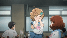 a girl with a bow in her hair is making a funny face in a classroom