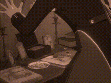 a black and white photo of a person sitting on a table