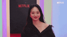 a woman standing in front of a netflix sign