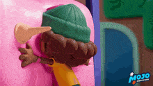 a cartoon character with a green hat and a yellow shirt that says mojo on the bottom