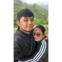 a man in a black jacket holds a woman in a black and white adidas jacket