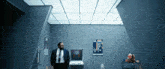 a man in a suit and tie is standing in a room