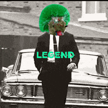 a man in a suit and tie is standing in front of a car with the word legend on it