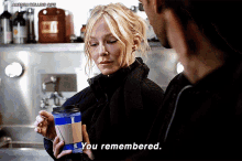 a woman holding a coffee cup that says i you remembered
