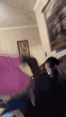 a woman is laying on a couch in a living room