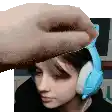 a person is wearing headphones and a hand is holding a piece of paper over their head .