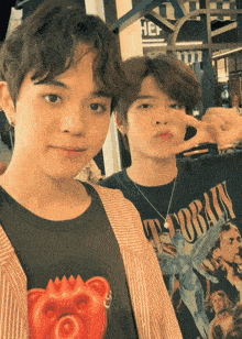 two young men are posing for a picture with one wearing a nirvana t-shirt