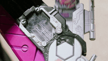 a close up of a purple and silver item with a button that says ' a ' on it