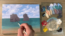 a painting is being painted on a canvas with a palette behind it that says " made in animatica "