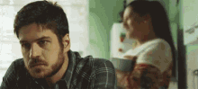 a man with a beard is sitting at a table in front of a woman .