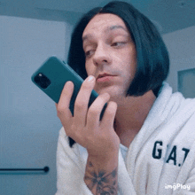 a man wearing a bathrobe and wig is holding a cell phone