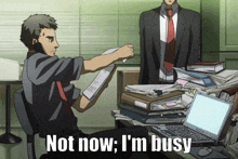 a man sitting at a desk holding a piece of paper with the words " not now i 'm busy " below him