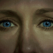 a close up of a woman 's blue eyes and nose