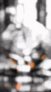 a blurry photo of a person 's face with a few orange spots