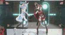 two anime characters are dancing on a stage in front of a crowd .