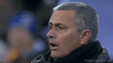 a close up of a man 's face with the words reaction gifs.me below him