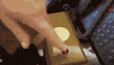 a person is pressing a button on a telephone next to a calculator .