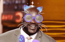 a man wearing glasses with cat ears on his face
