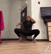 a woman is squatting down in a room with the hashtag cuddapotato in the corner