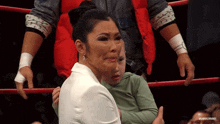 a woman is hugging a child in a wrestling ring with a caption that says ' rubic crude ' on it