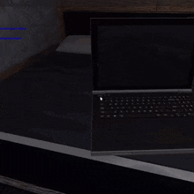 a roblox character wearing a hat and tie is sitting in front of a laptop computer .